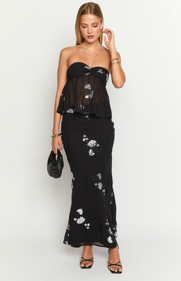 Black maxi skirt with scattered silver floral embroidery and a subtle flared hem