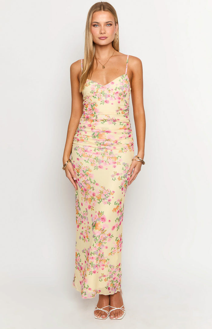 Yellow floral maxi dress with a sweetheart neckline, spaghetti straps, and a ruched fitted bodice