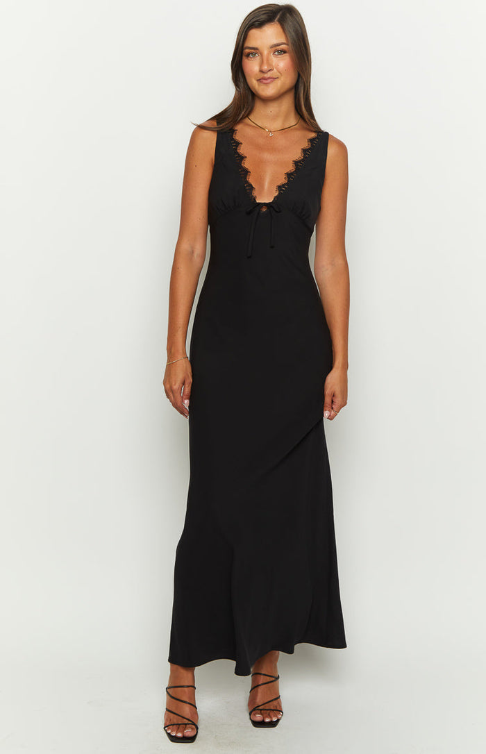 Black maxi dress with a deep V-neckline, delicate lace trim, and a tie-front detail