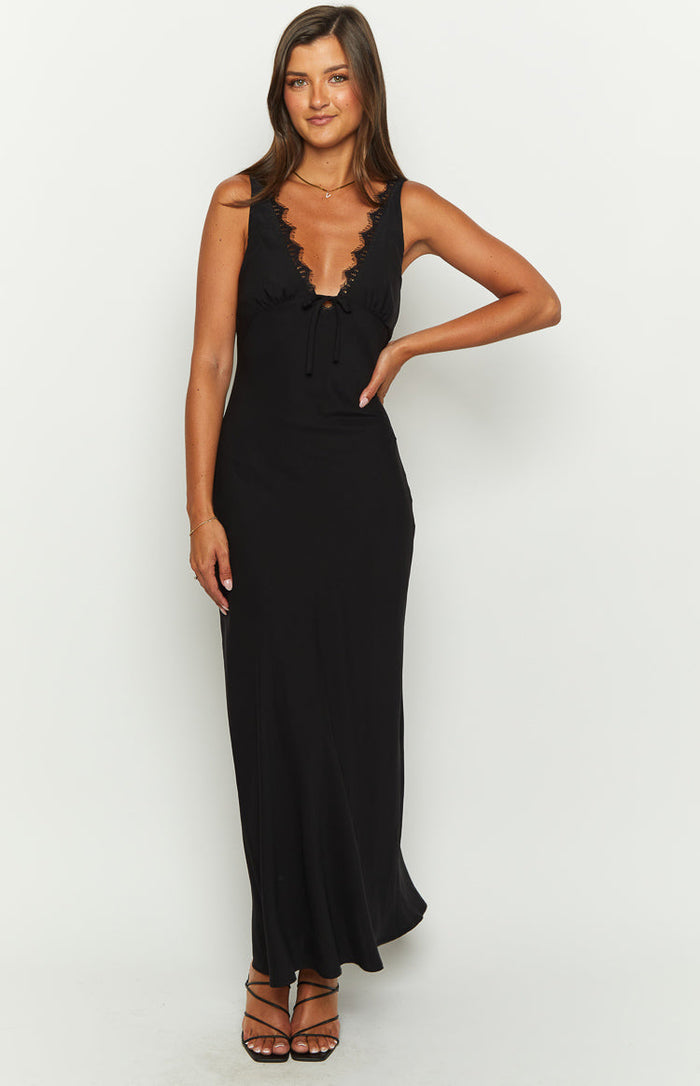 Black sleeveless V-neck maxi dress with lace trim and a front tie detail, flowing to the floor