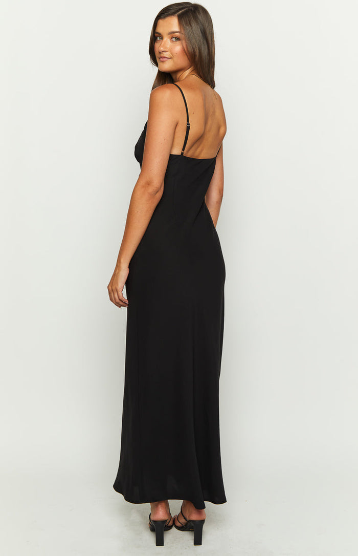 Side view of a black maxi dress with thin adjustable spaghetti straps and a low back