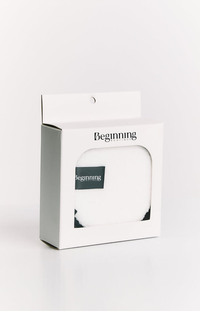 White retail box with a clear window displaying a white fluffy reusable face wash pad