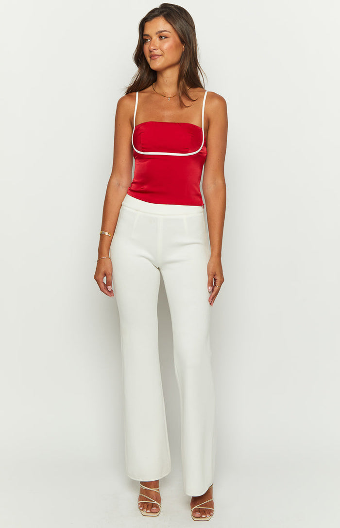 Red satin fitted top with a straight neckline, white piping detail, and thin spaghetti straps