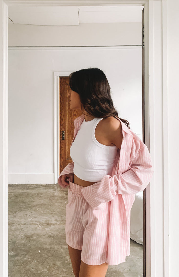 The Sarah Shorts in pink pinstripe, loose fit with elasticated waist, worn with a matching open shirt