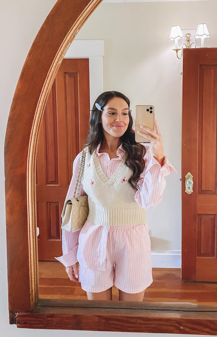 Pink pinstripe shorts with a relaxed fit and a visible front tie detail