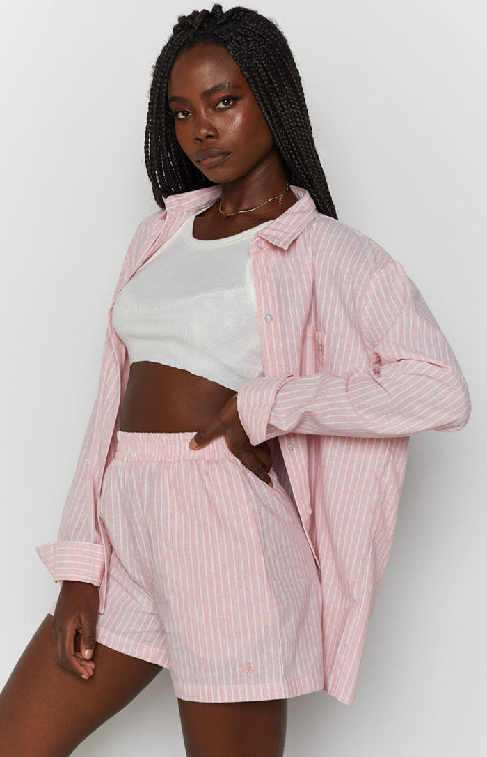 Pink pinstripe shorts with an elasticated high waist and relaxed fit, made from textured fabric