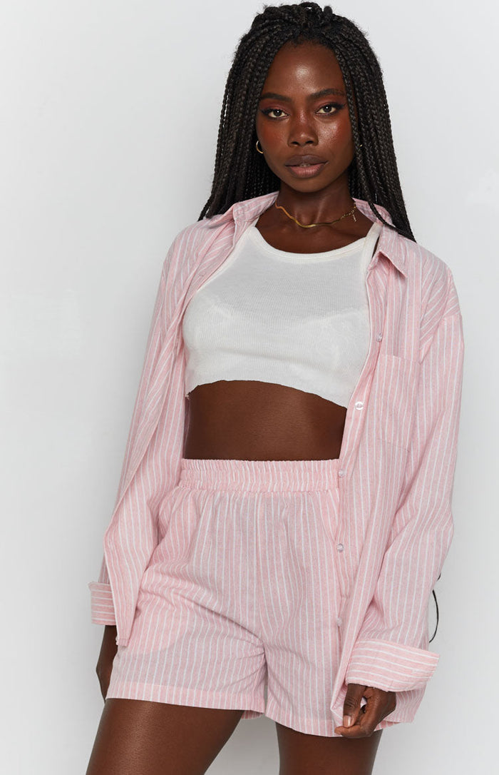 Pink pinstripe shorts with an elasticated waist and a matching collared button-up shirt
