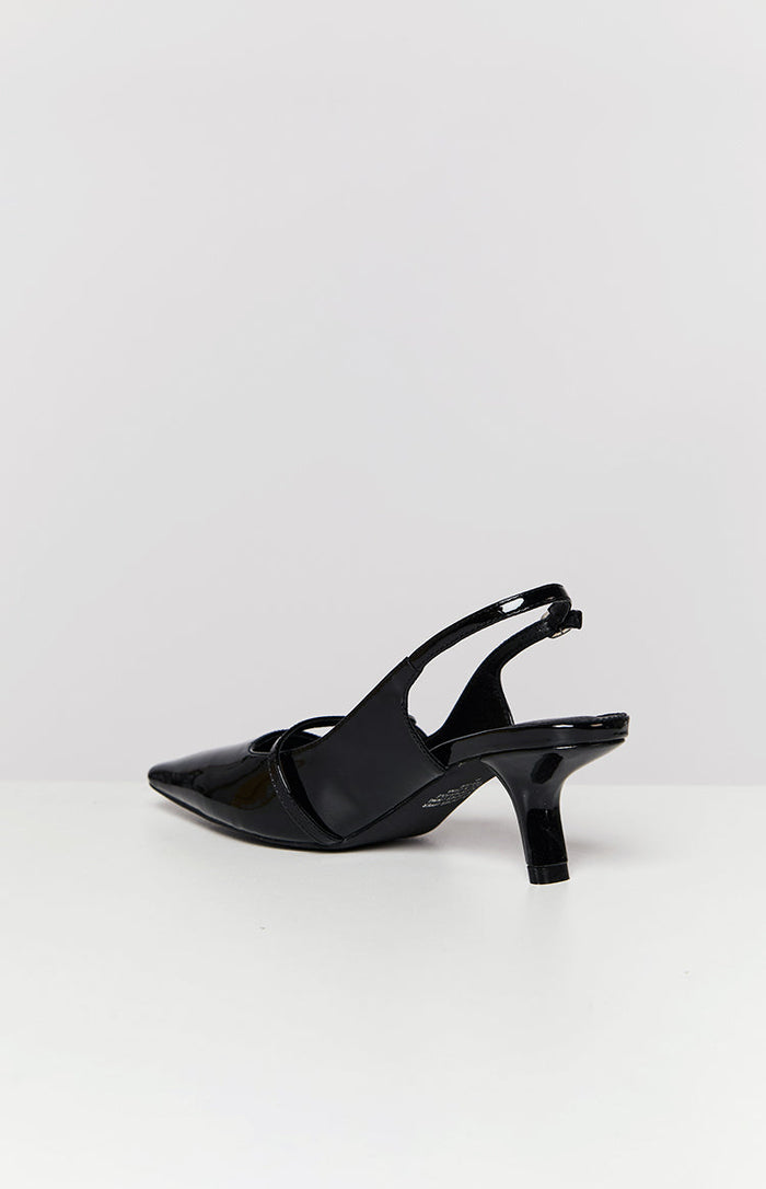Side view showing the adjustable slingback strap and low kitten heel of a black patent shoe