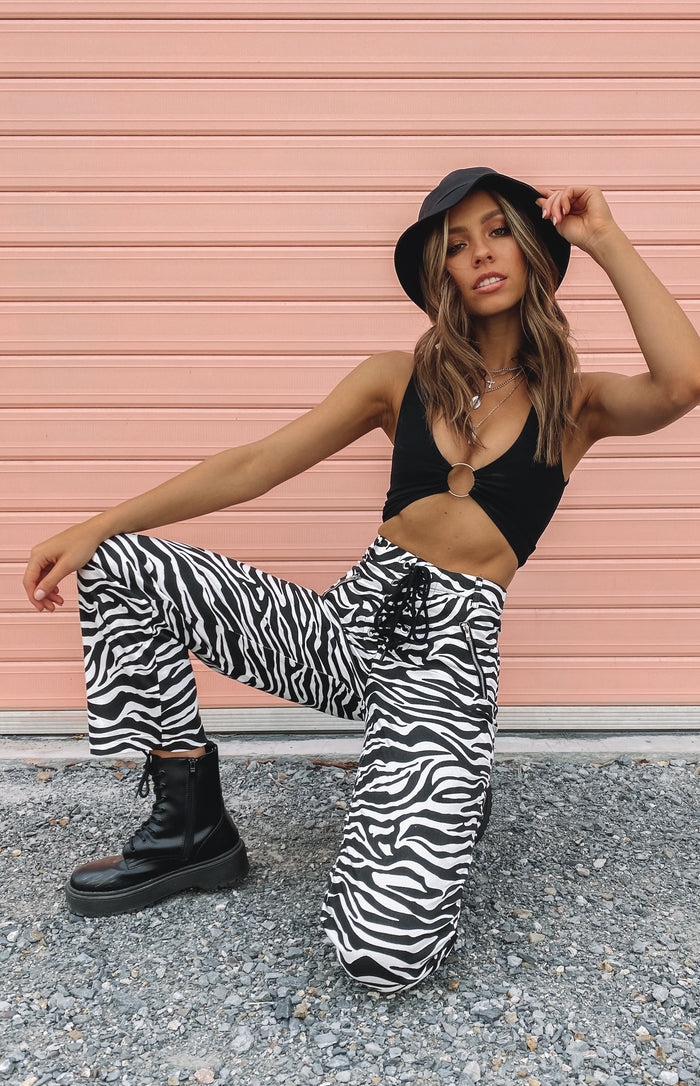 Black and white zebra print wide leg pants with a lace-up front and practical side zipper pockets