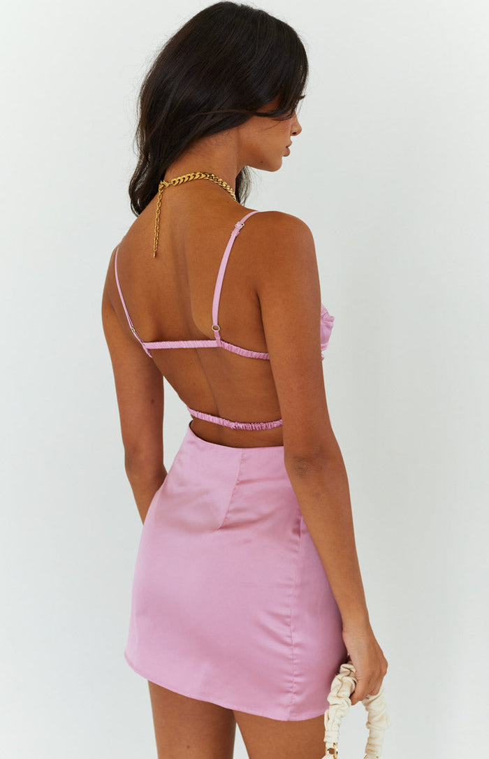 Rear view of a pink satin mini dress with thin adjustable straps and an open back featuring two elasticated bands