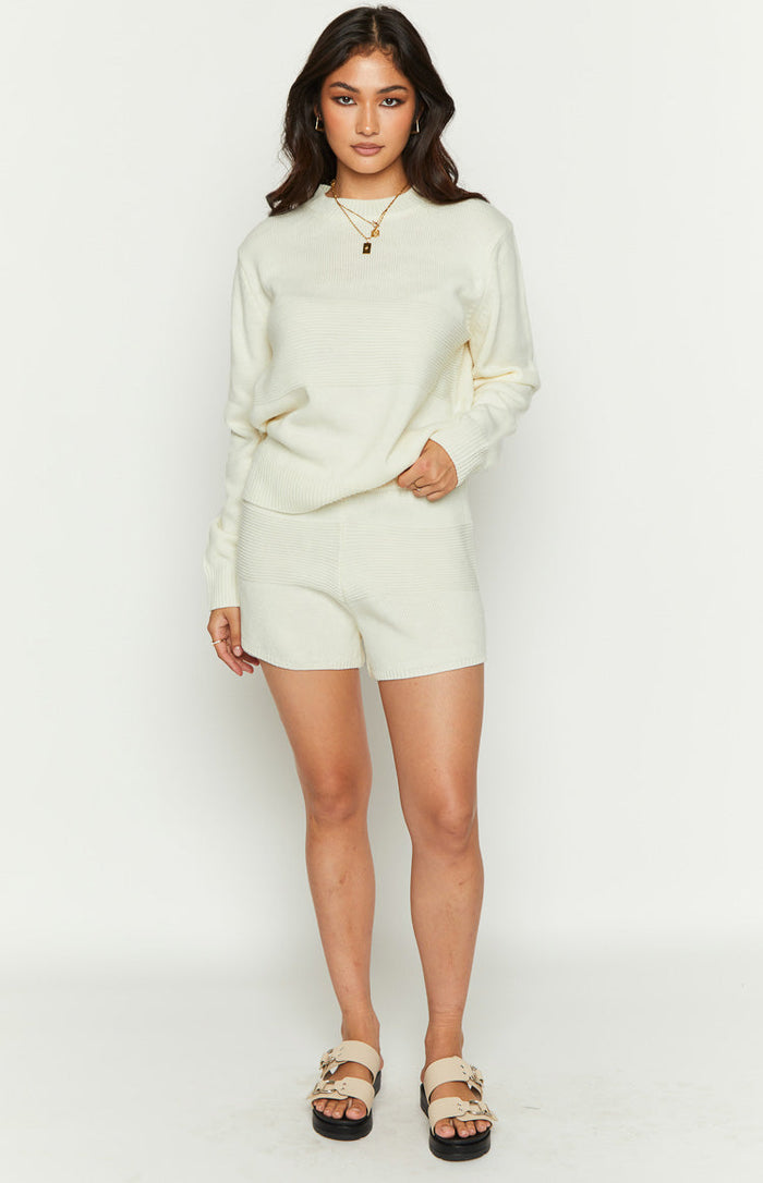 Front view of white high-waisted knit shorts with a ribbed texture and short length